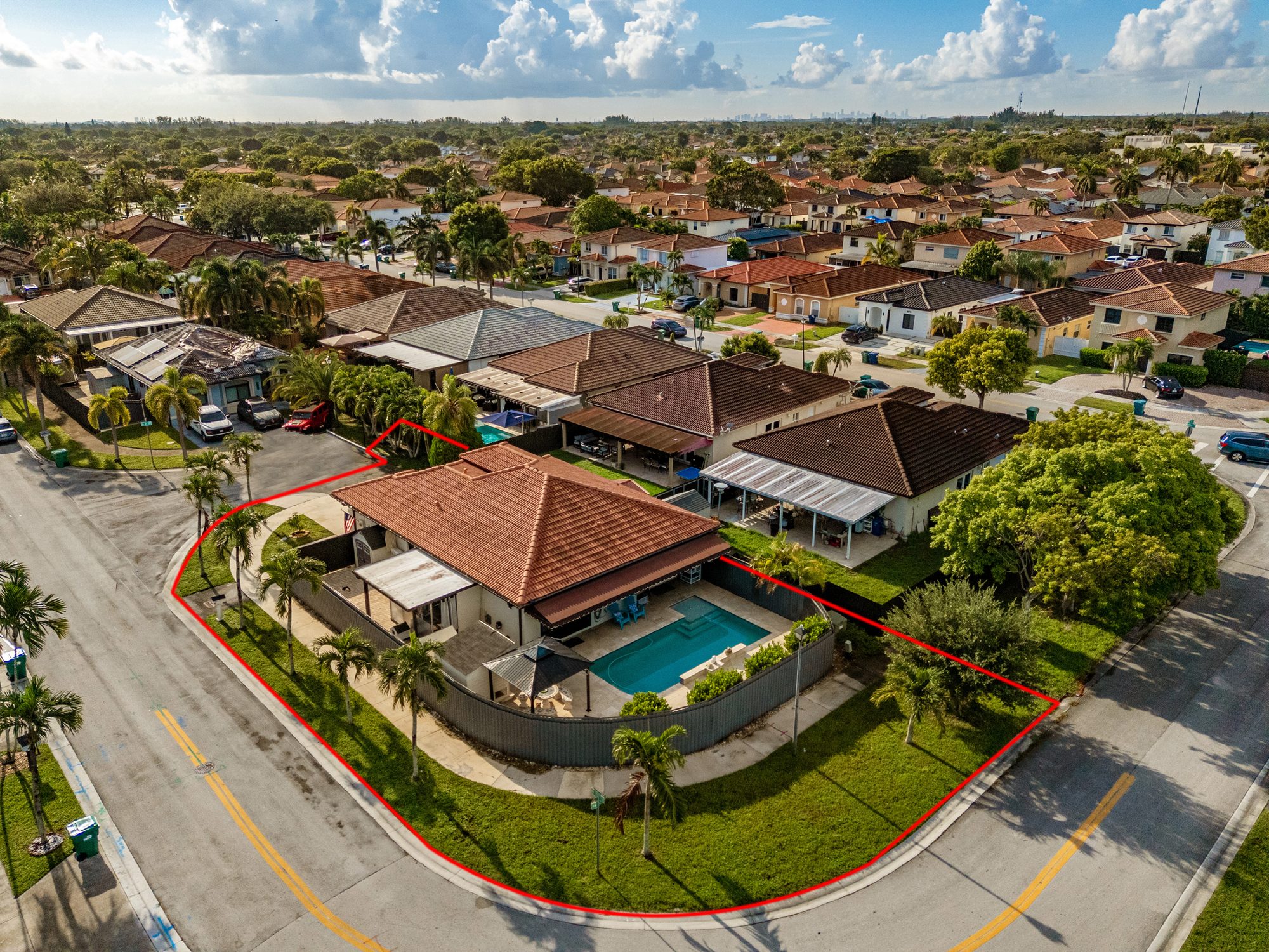 Drone view of the corner lot and saltwater pool