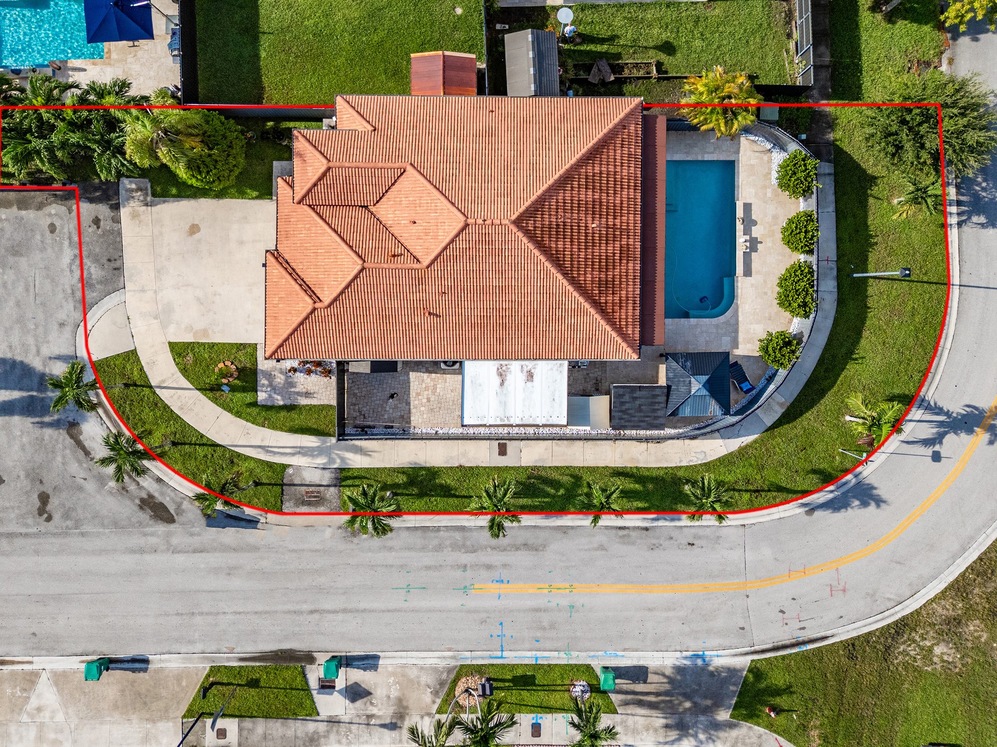 Overhead drone view of the roof, pool and lot