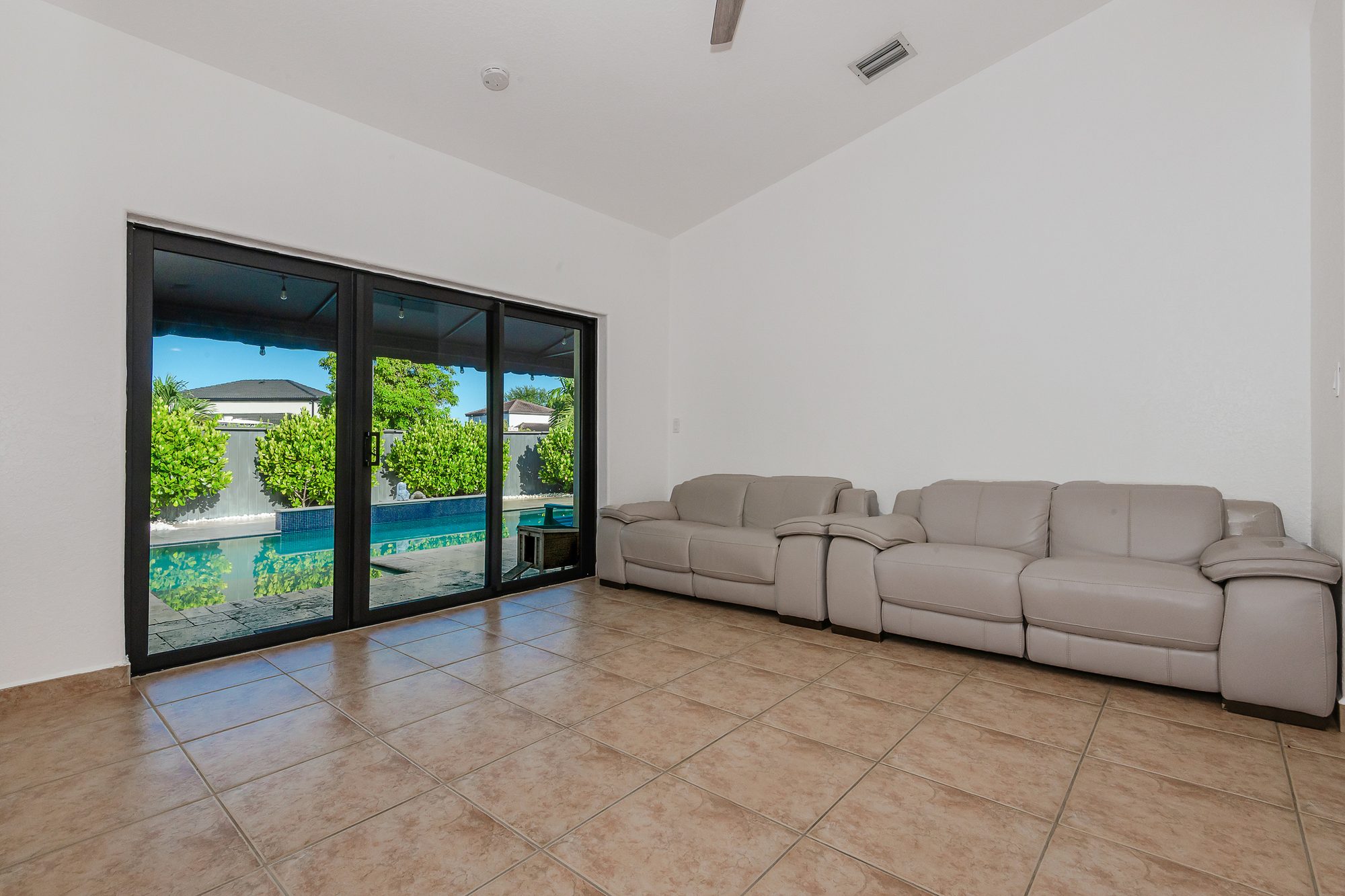 Living room with a view of the pool through sliding glass doors