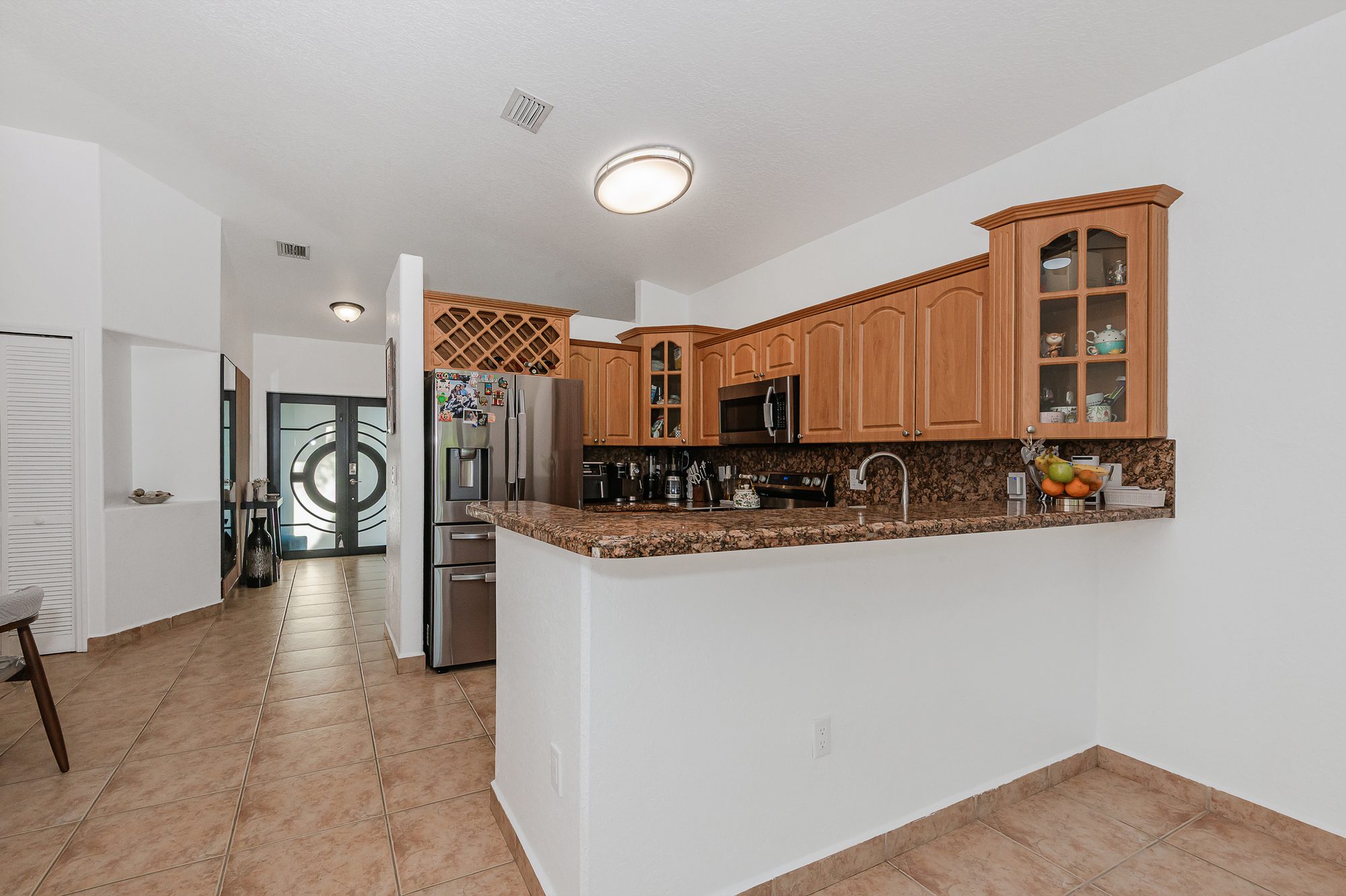 Kitchen with granite countertops and wood cabinetry