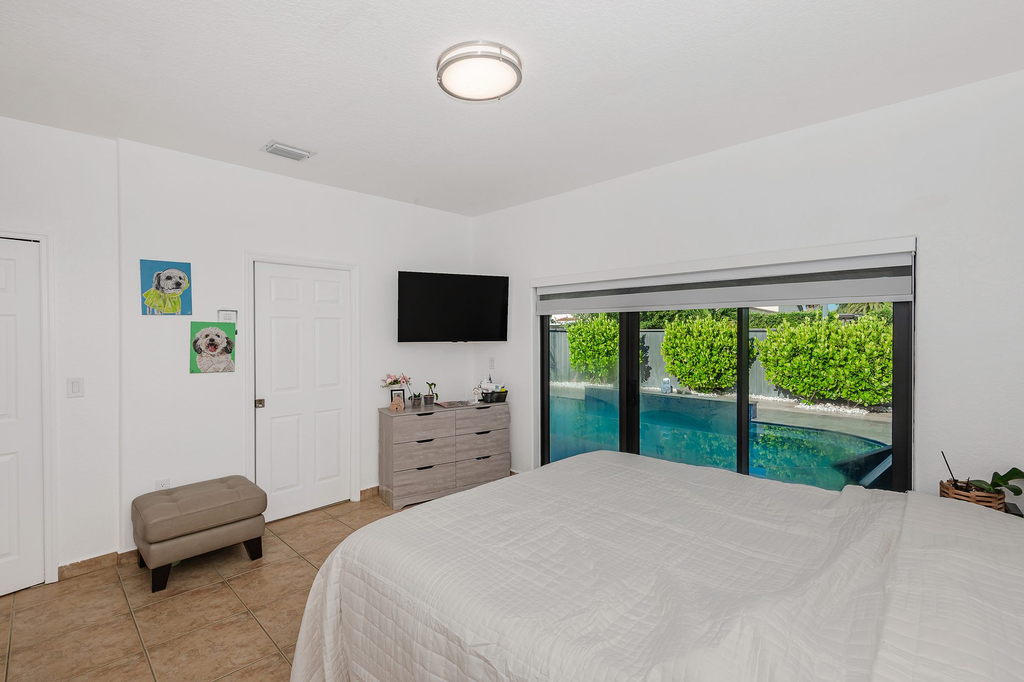 Bedroom with sliding doors facing the pool