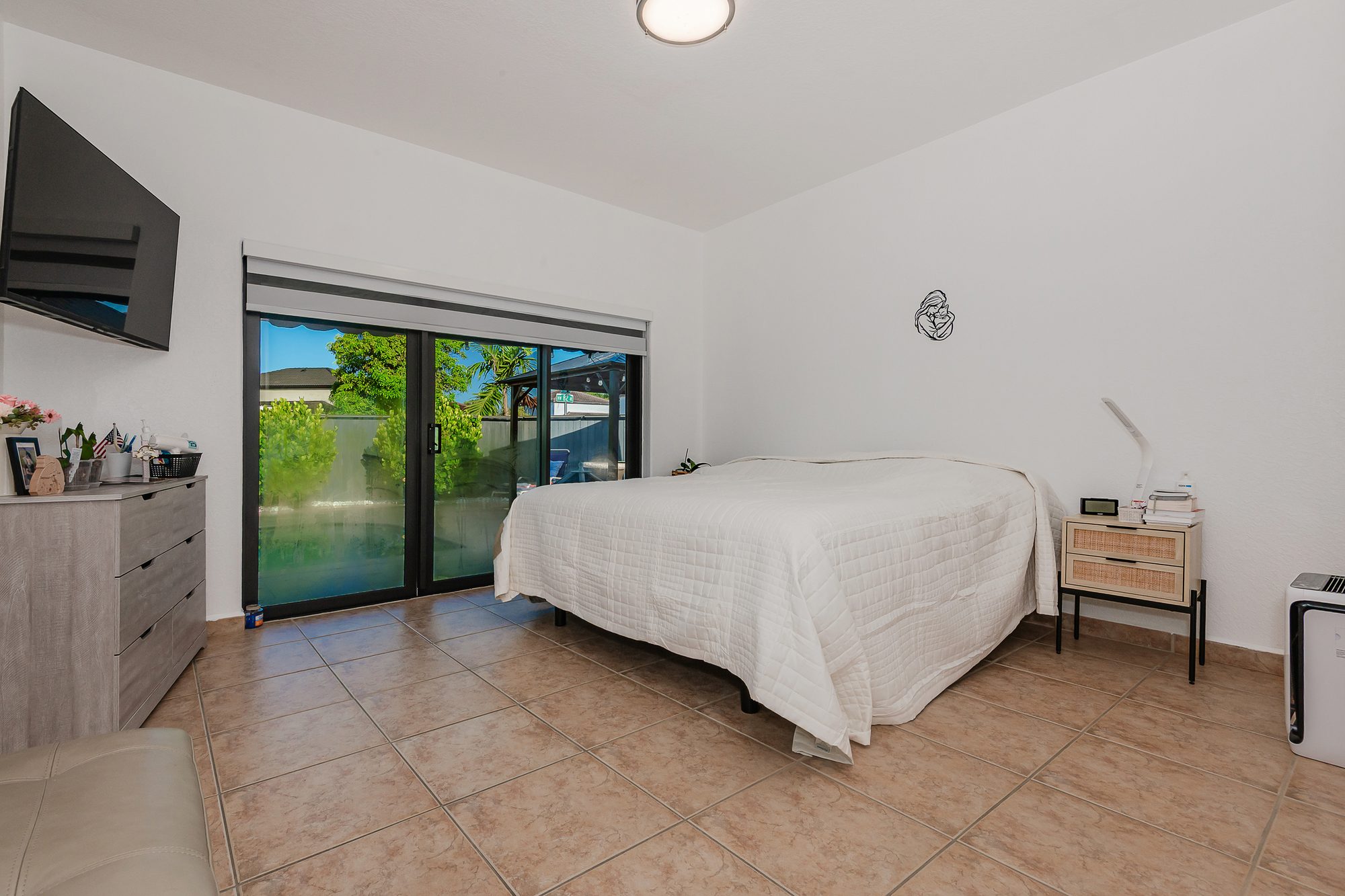 Bedroom with sliding doors to the backyard