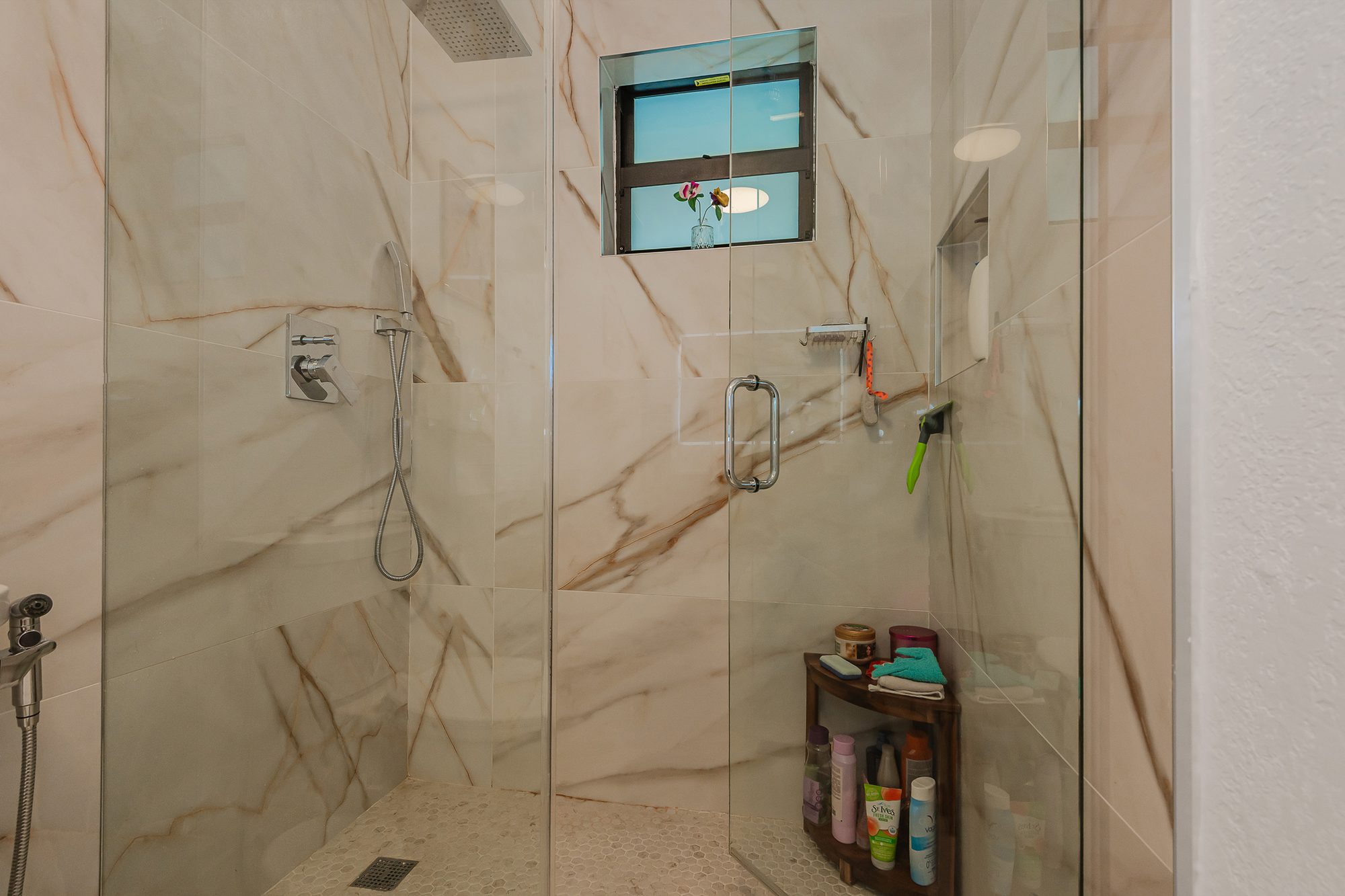 Primary bath with marble-look walk-in shower